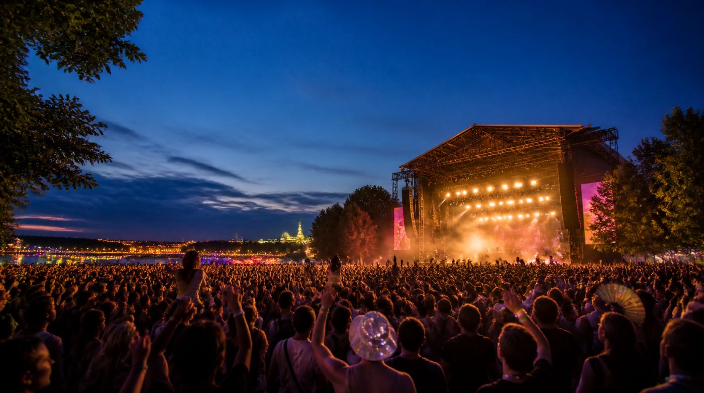 Festival crowd watching an illuminated outdoor stage at Sziget Festival in Budapest